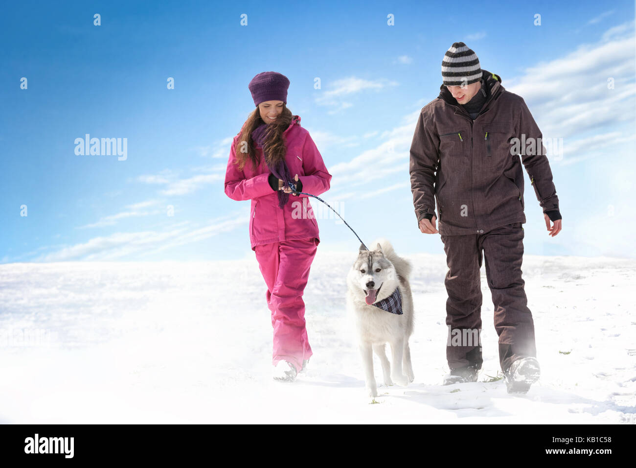 Young couple walking with dog Stock Photo - Alamy