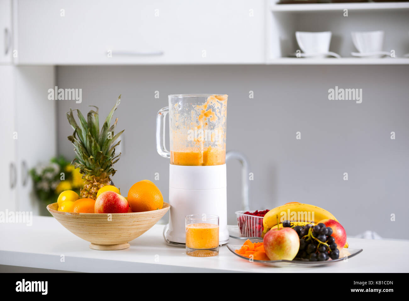 Prepared smoothies and healthy smoothie ingredients in blender with
