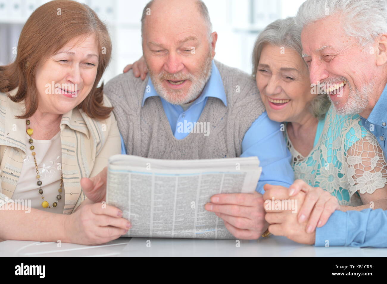 senior couples reading newspaper Stock Photo