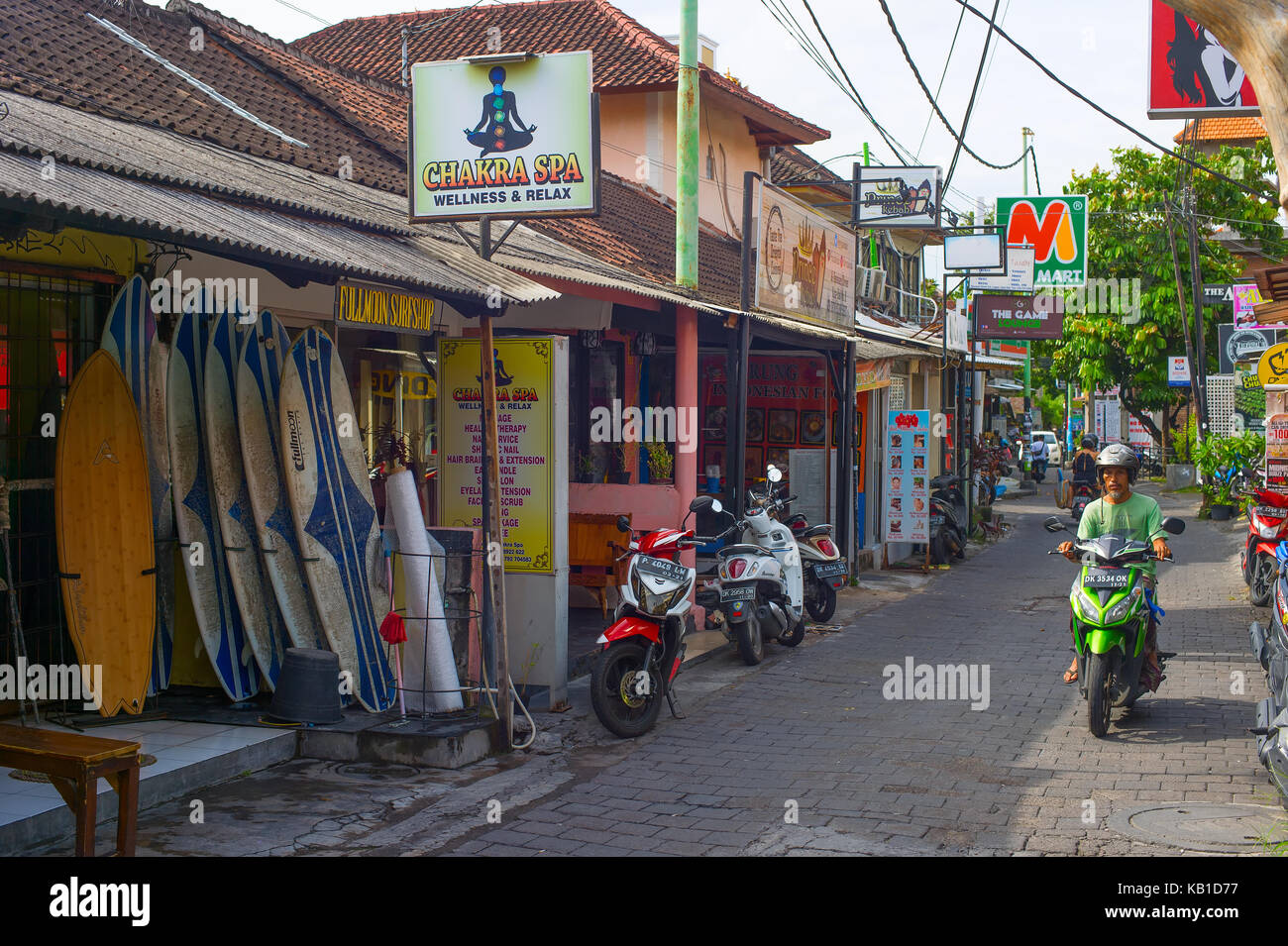 KUTA, BALI ISLAND, INDONESIA - JAN 28, 2017: Typical street with local touristic shops in Kuta. Kuta is the most famous and crowded tourist destinatio Stock Photo