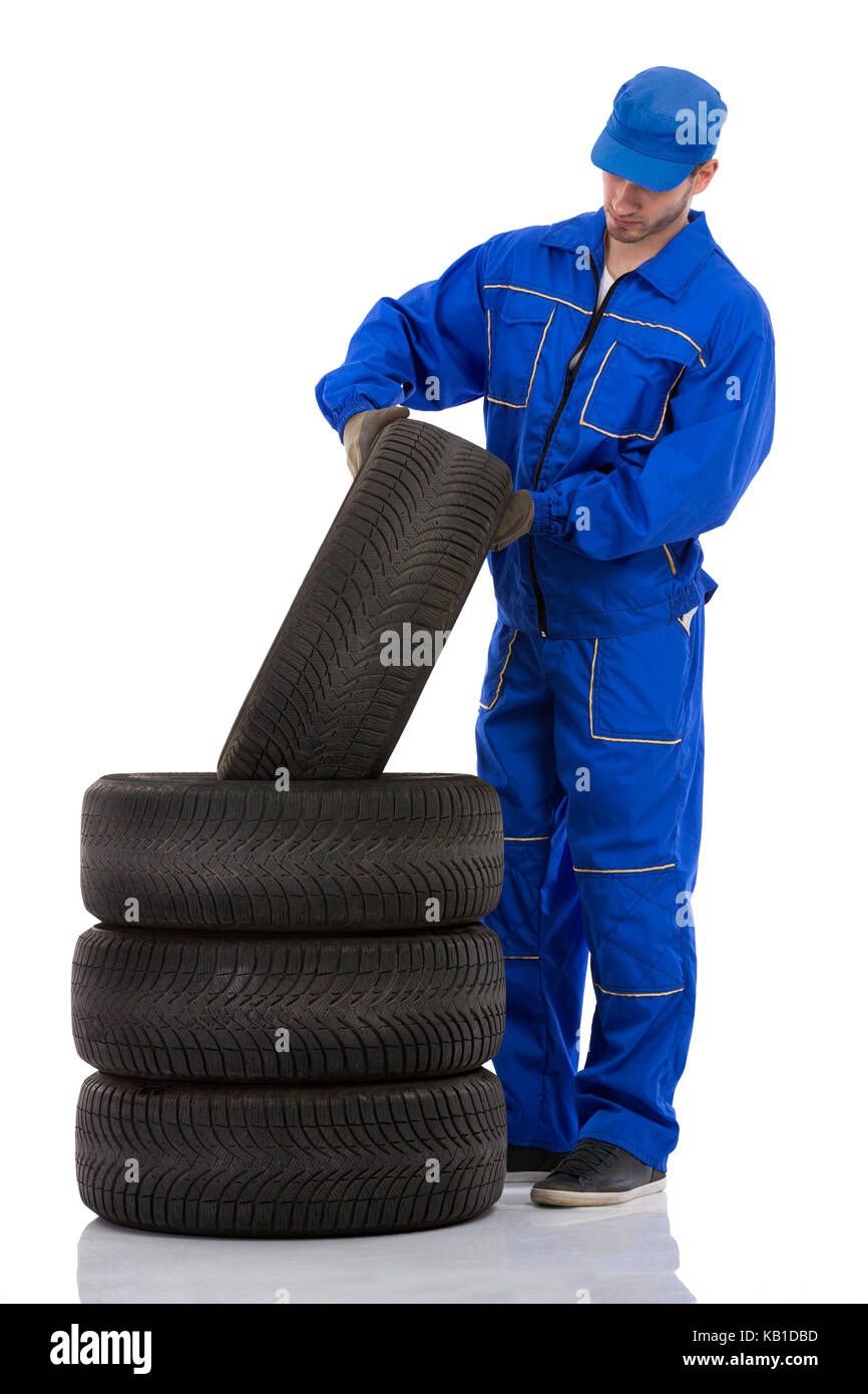Young motor mechanic with  a tyre Stock Photo