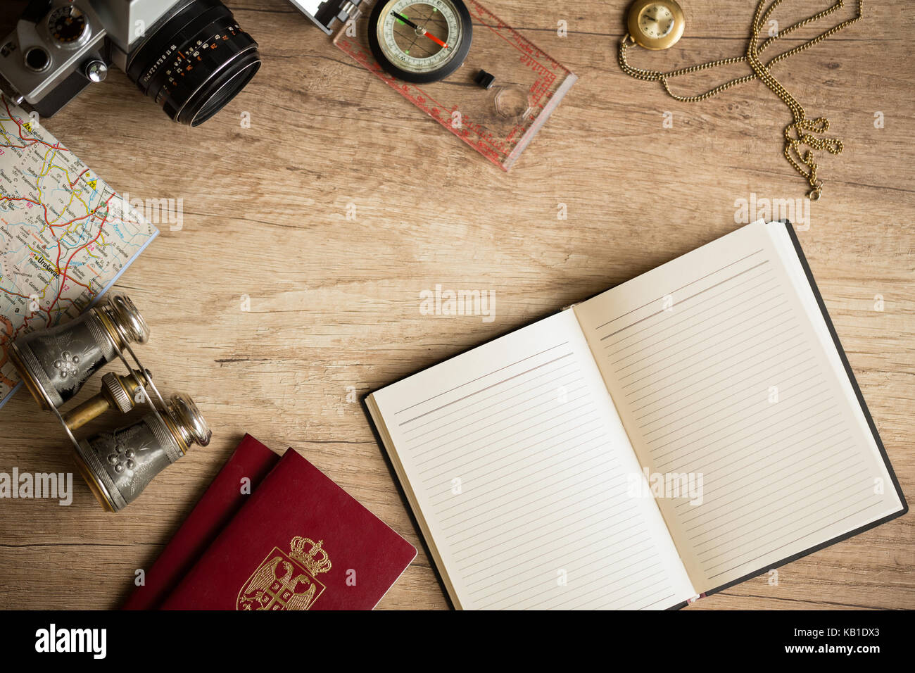 Old fashionable travel stuff on wooden table Stock Photo