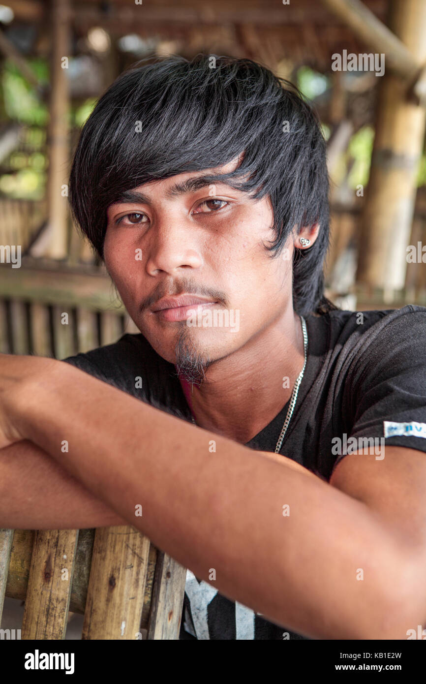 Portrait of a eighteen-year old Filipino teenage boy with black hair, moustache and gotee. Stock Photo