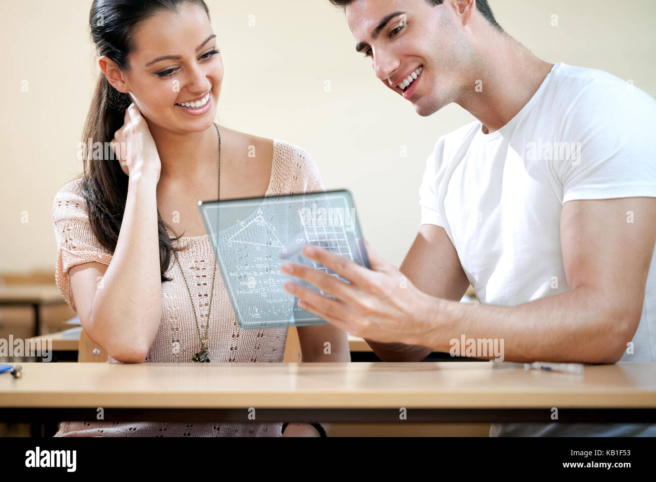 Couple of students using  futuristic digital tablet Stock Photo