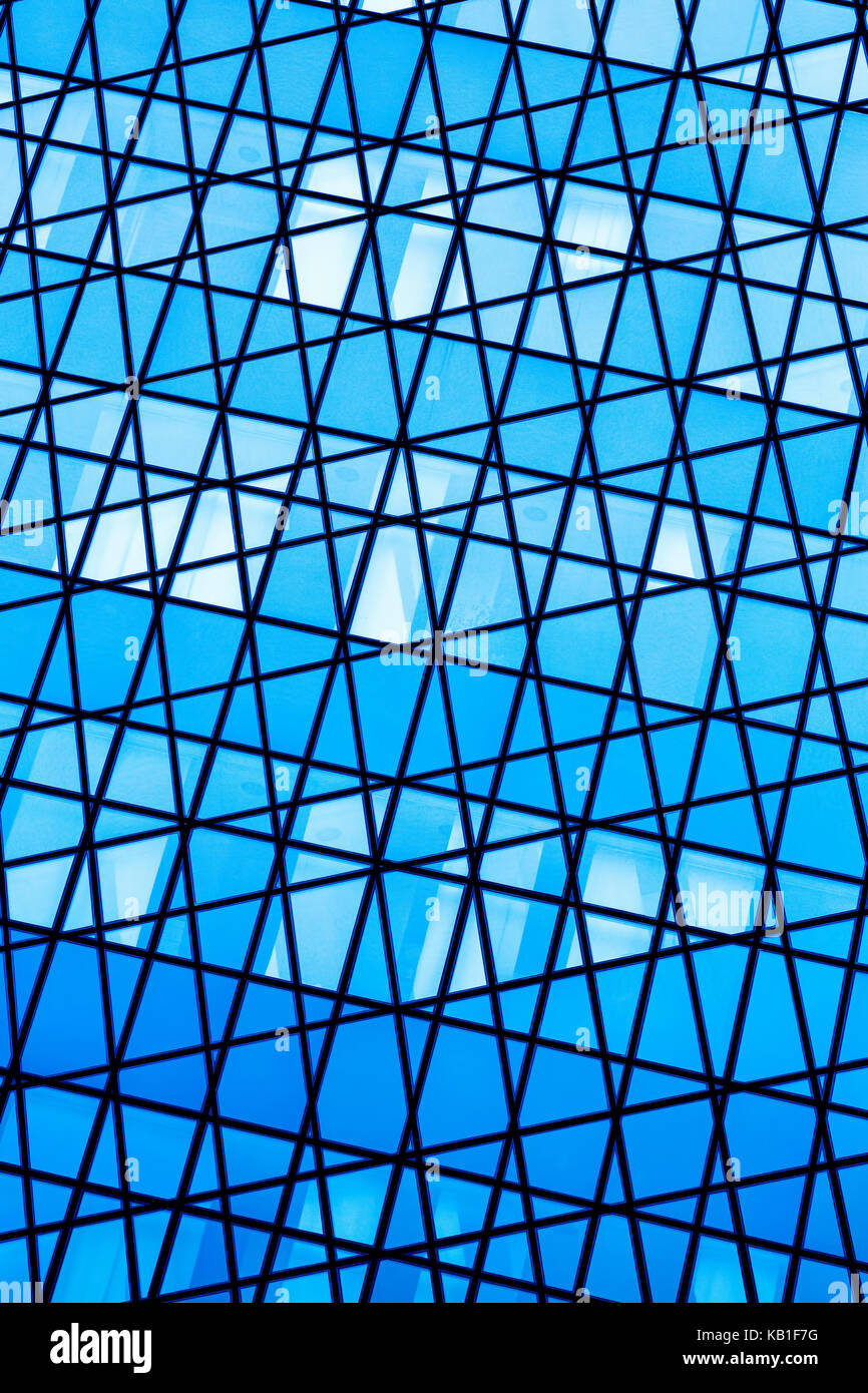 Abstract of a wall of windows in various shades of blue, silver and ...