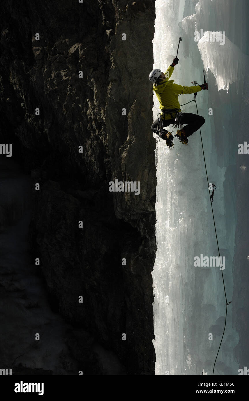 Young man by the ice climbing in the gulch of Pontresina, Switzerland, Stock Photo