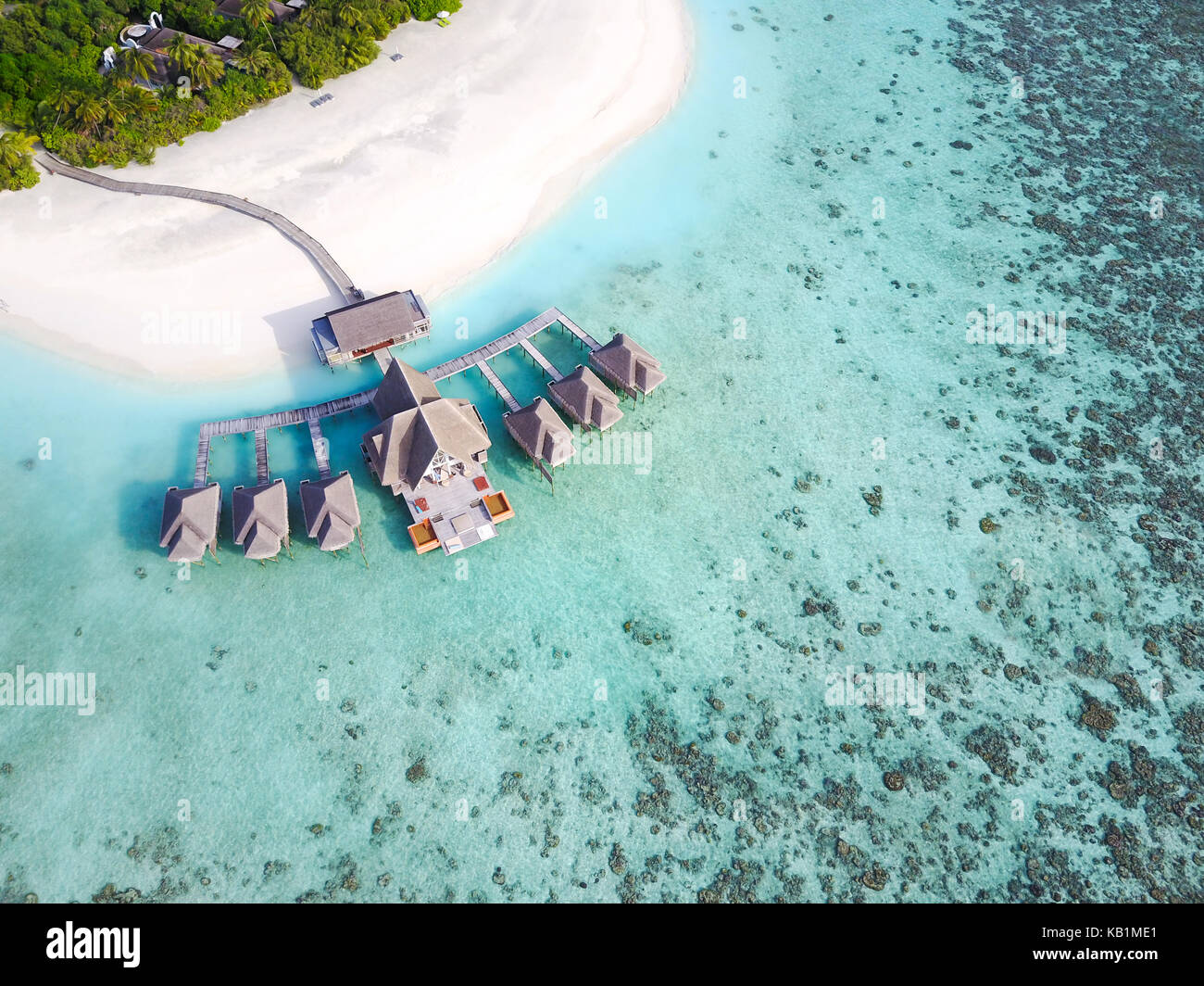 Aerial view of a tropical paradise resort on the edge of a coral reef ...