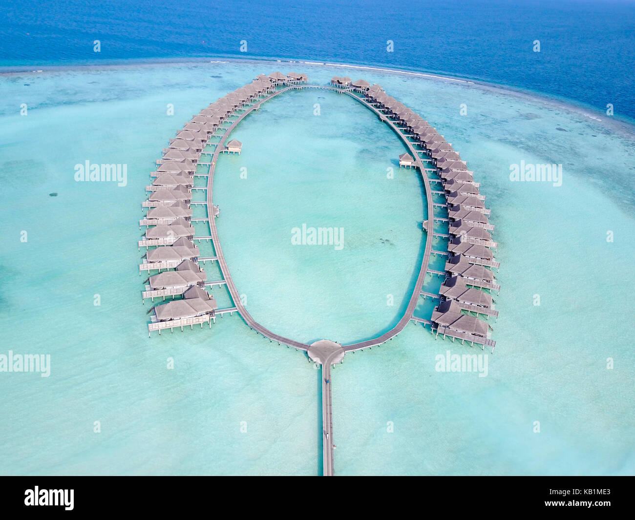 Aerial view of a tropical paradise resort on the edge of a coral reef ...