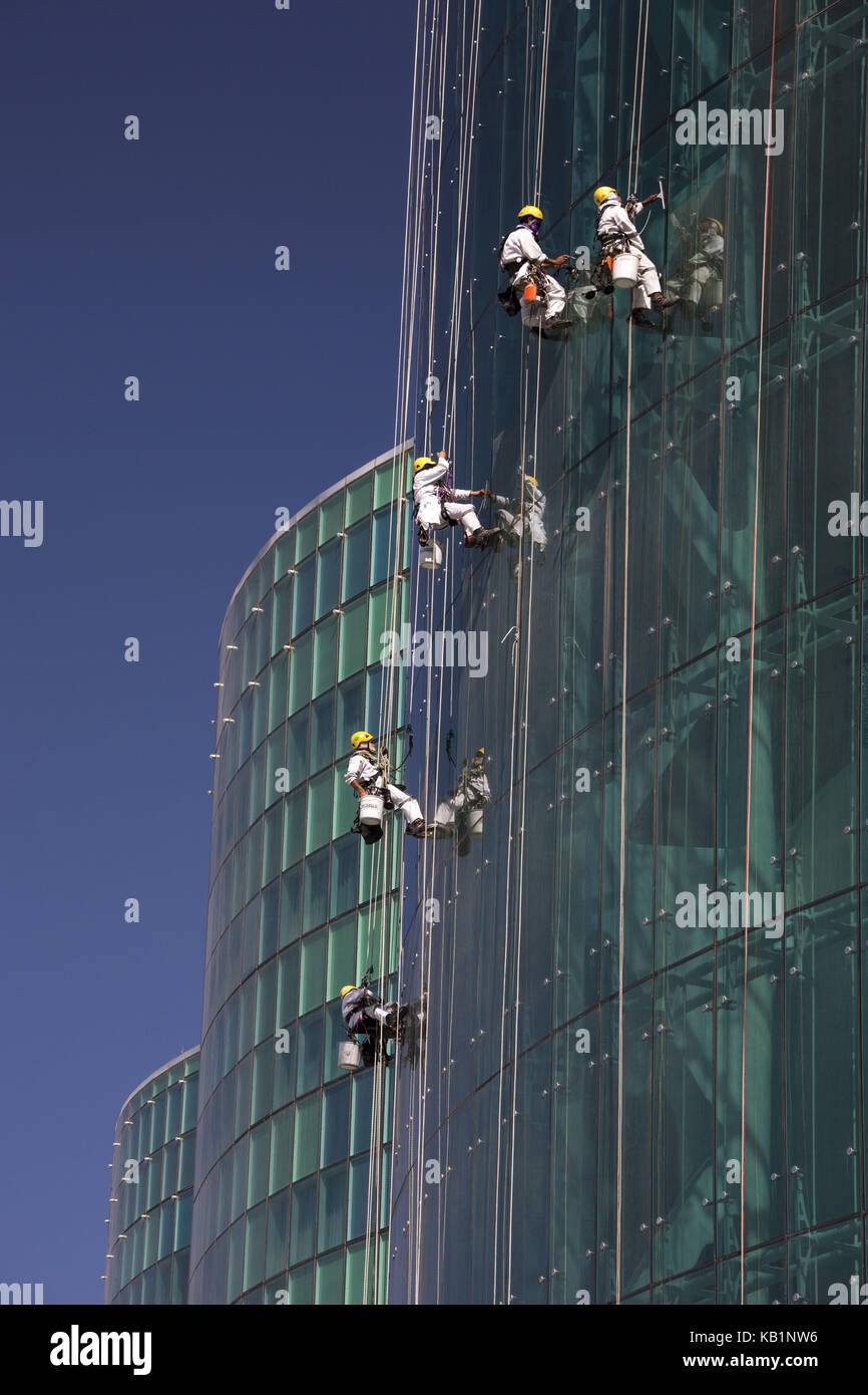 Workers clean window in a building, Abu Dhabi, Stock Photo