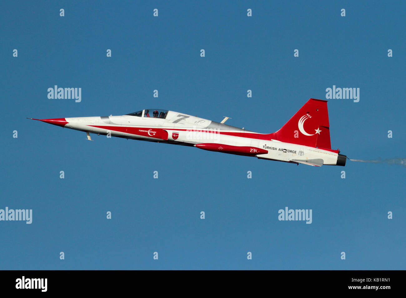 NF-5 pilot of the Turkish Stars military display team waving to spectators while flying a solo slow pass at an airshow Stock Photo