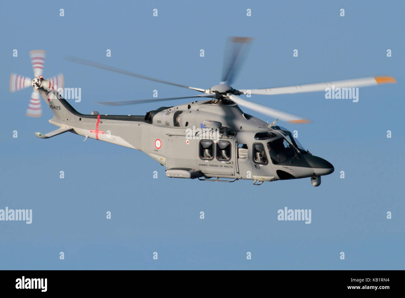 Helicopter flying in the air. AgustaWestland AW139 maritime patrol and search and rescue aircraft of the Armed Forces of Malta against a blue sky. Stock Photo