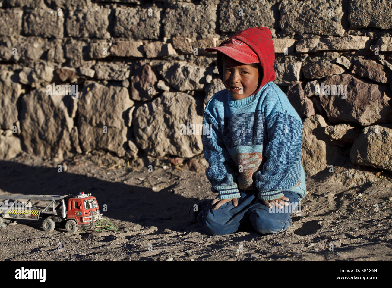 Bolivia, Los Lipez, San Pedro de Quemez, boy, toys, Stock Photo