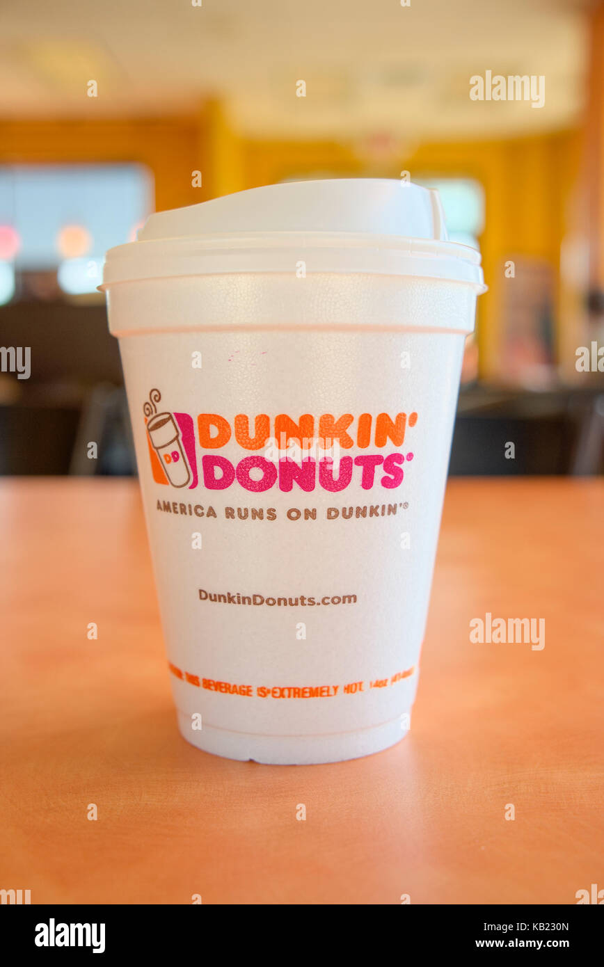 White styrofoam cup of hot Dunkin Donuts coffee inside the fast food restaurant in Montgomery, Alabama, USA. Stock Photo