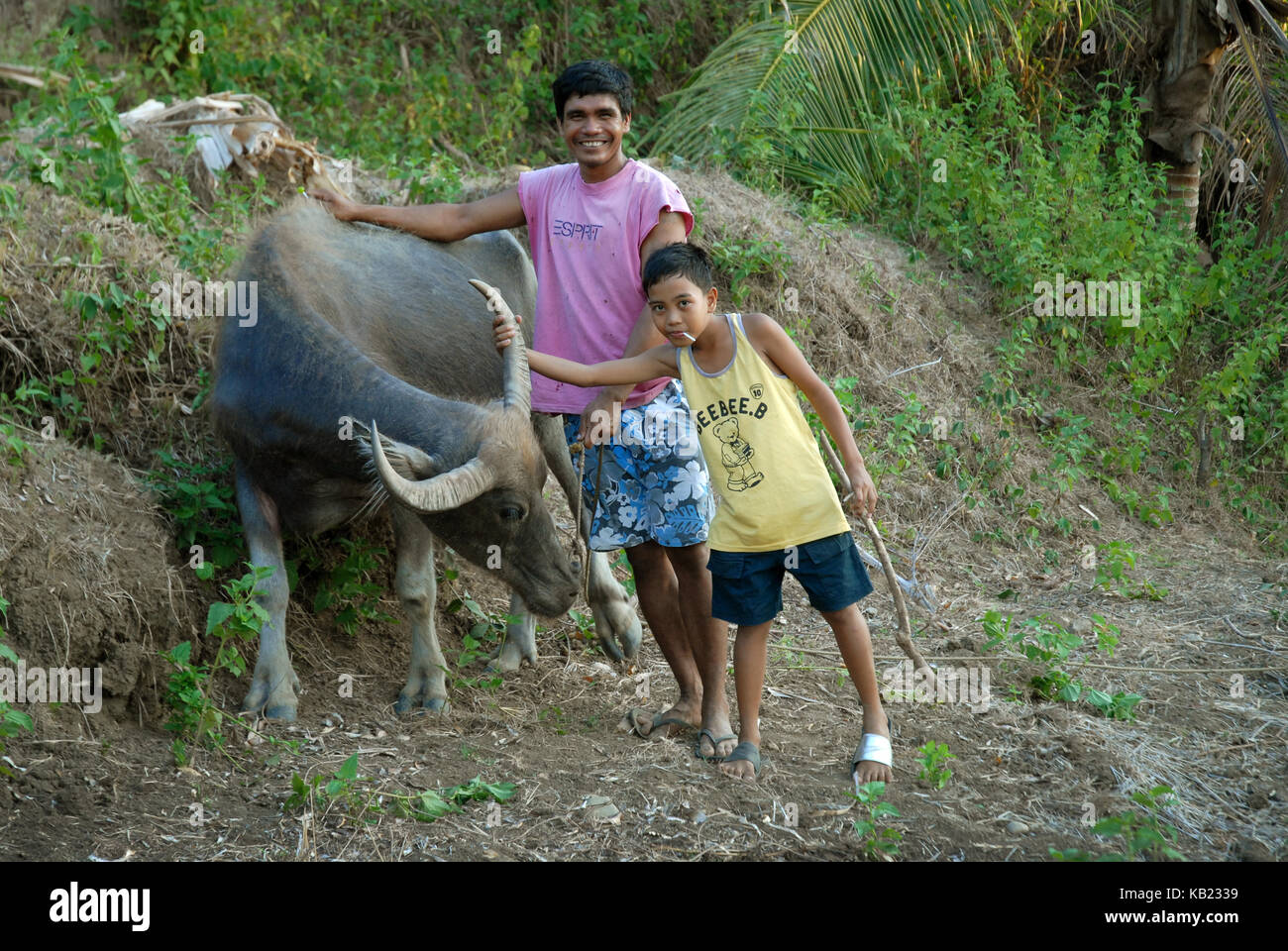 Father and son with their Carabao, Mabini Sur, San Joaquin, Iloilo, Philippines. Stock Photo
