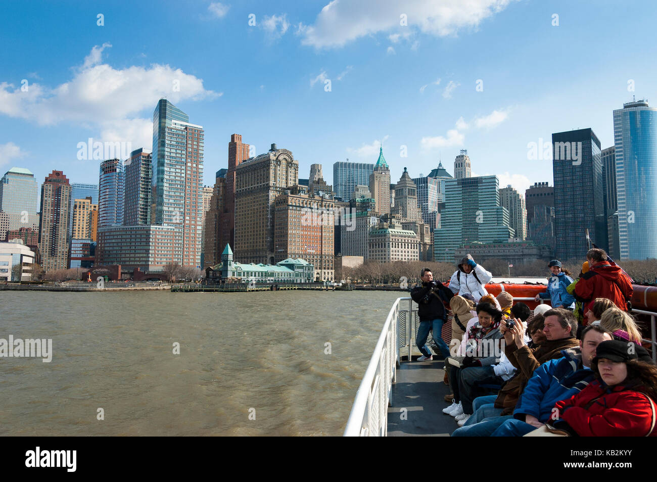 Tourists in a ferry departing from the Port of New York, Battery Park, in a ferryboat tour to Liberty Island, New York, NY, USA. Stock Photo