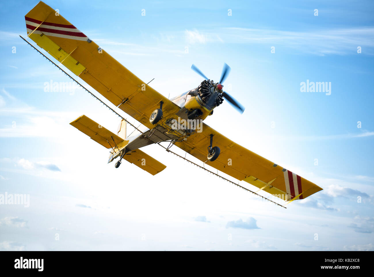 aircraft in red and orange against blue sky Stock Photo