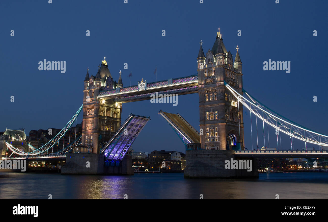 Tower Bridge at night open for ships to pass through in London, England, UK Stock Photo