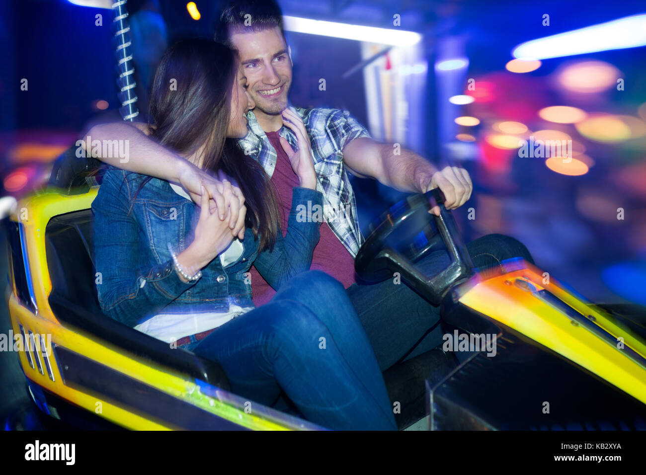 Young couple driving in a bumper car, dodgem ride Stock Photo Alamy