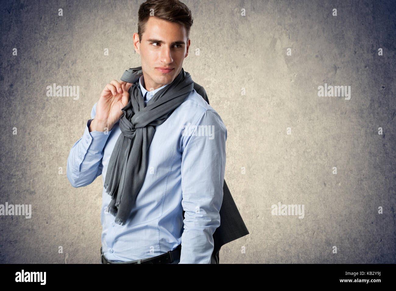 Young handsome man holding jacket over shoulder Stock Photo
