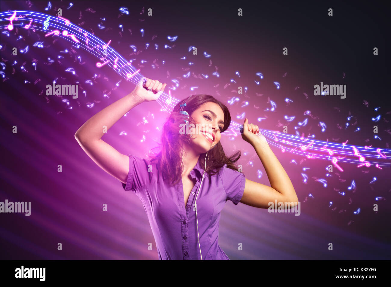 Happy young girl dancing with abstract sheet music system Stock Photo