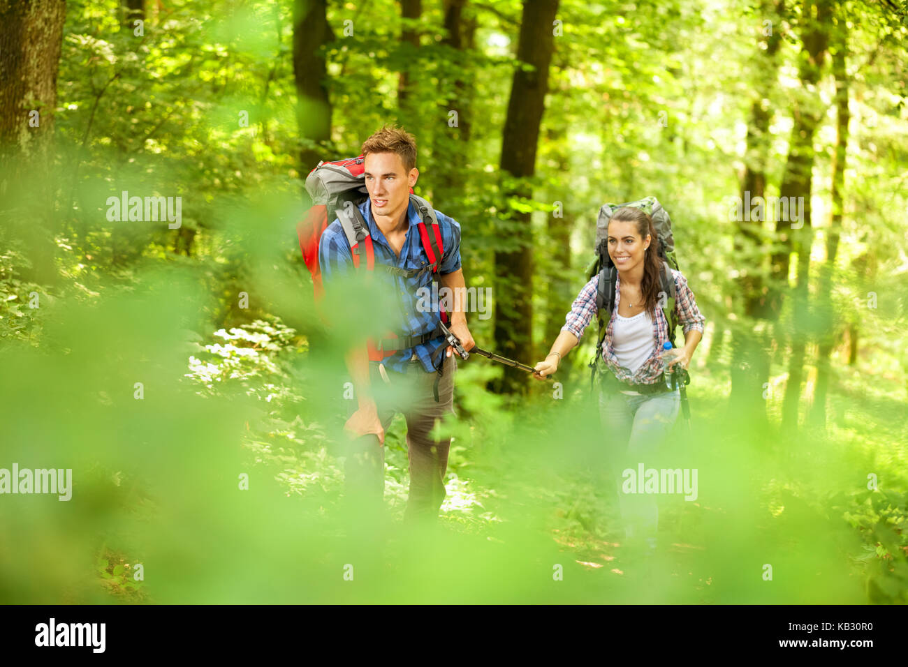Hiking Man and Woman in forest Stock Photo - Alamy