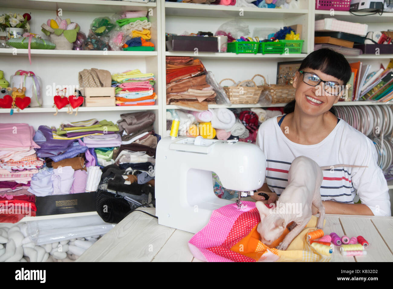 Beautiful and young seamstress with a measuring tape on her neck Stock  Photo by ©stockufa 349262122