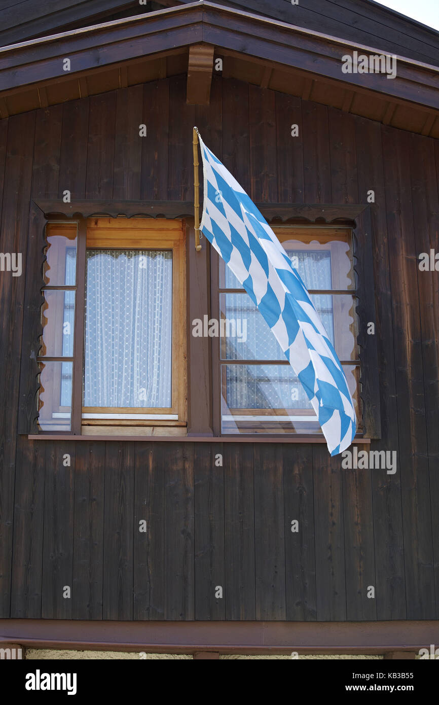 Germany, Bavaria, Werdenfelser Land (region), Garmisch-Partenkirchen, Bavarian flag, wooden house, Stock Photo