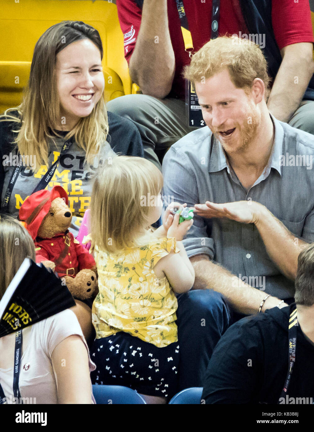 Prince Harry plays with Emily Henson, daughter of Hayley Henson (left) as he attends the Sitting Volleyball Finals at Mattamy Athletic Centre during the 2017 Invictus Games in Toronto, Canada. Stock Photo