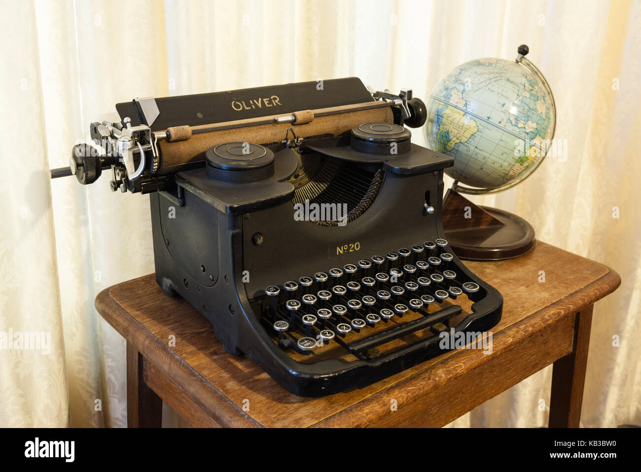 A typewriter and globe on a desk Stock Photo