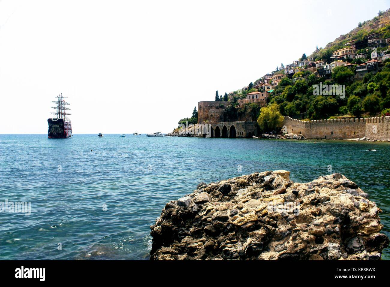 View of the old shipyard Kyzyl Kule from the beach near the Red Tower (Alanya, Turkey). Stock Photo
