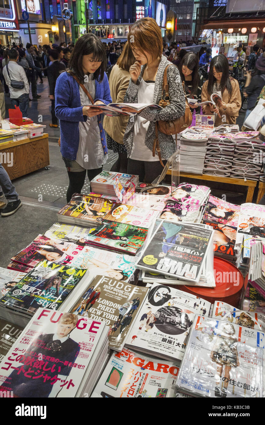 Japan, Honshu, Kansai, Osaka, Namba, Dotonbori Street, newspaper shop, customer las magazines, Stock Photo