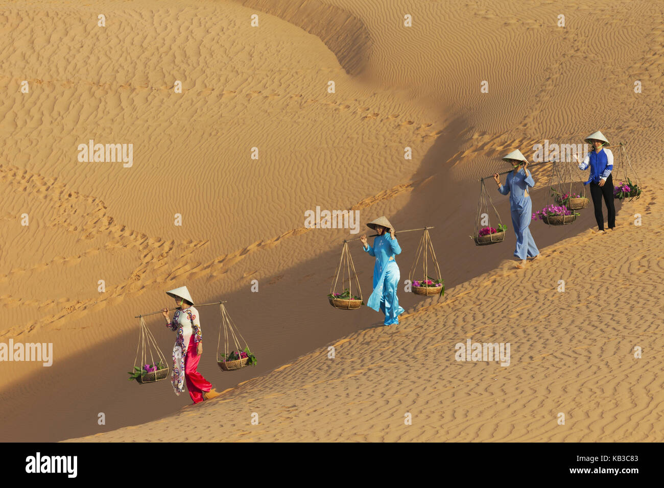 Vietnam, Mui Ne, Sand dune, women carry costs, Stock Photo
