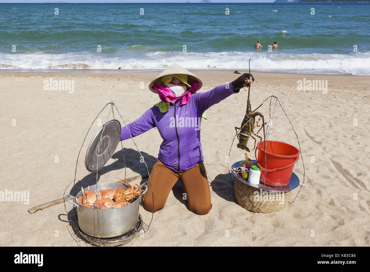Vietnam, Nha Trang, Nha Trang Beach, woman sells fresh seafood on the beach, Stock Photo