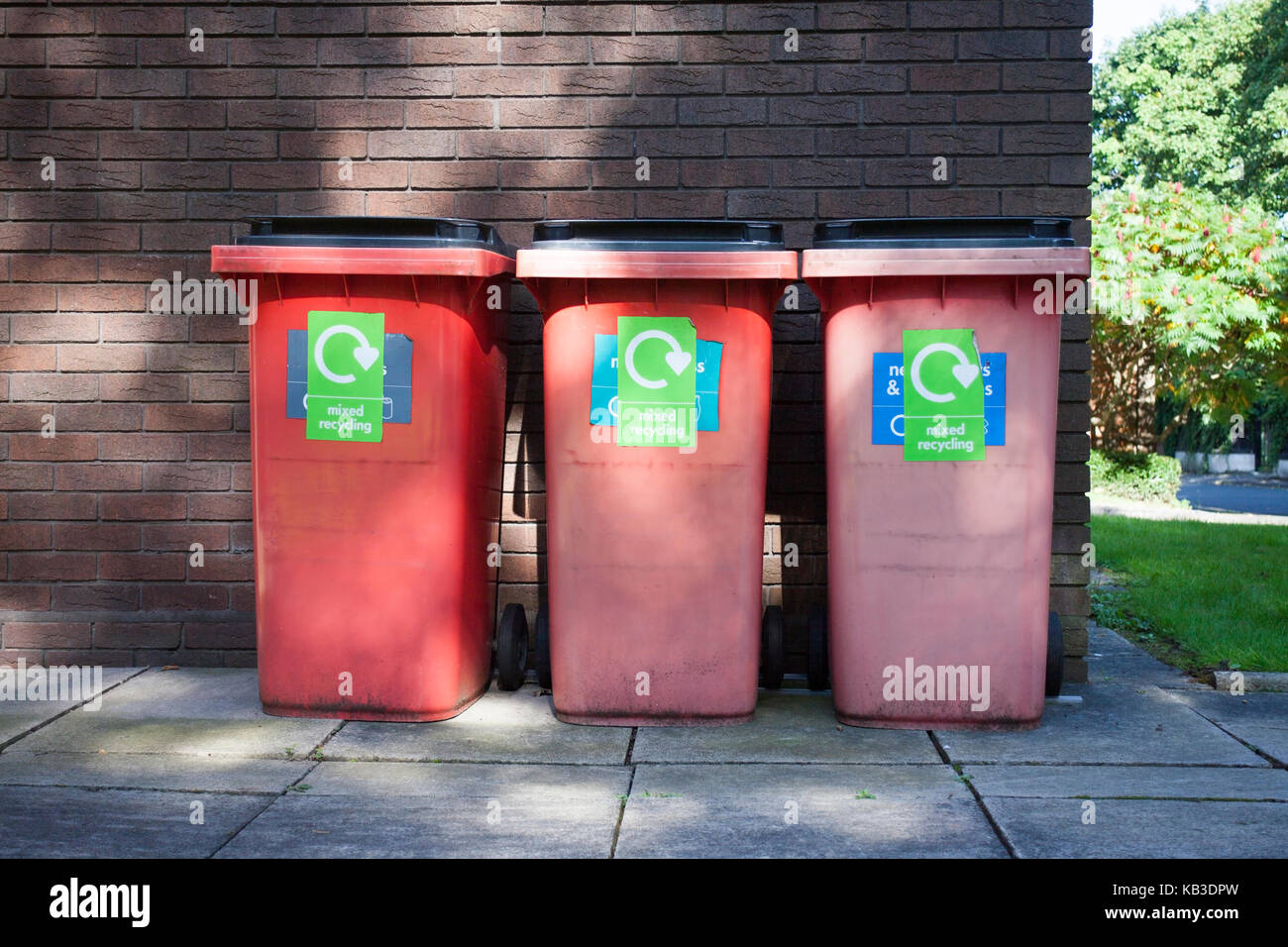 Three red garbage, trash bin eith writing Stock Photo Alamy