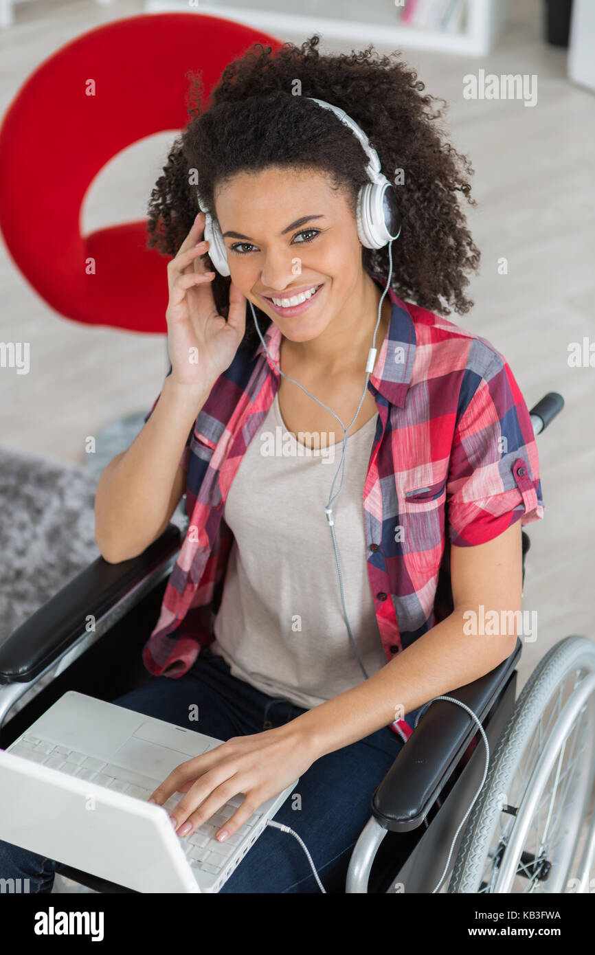 smiling disabled woman in wheelchair with laptop Stock Photo - Alamy