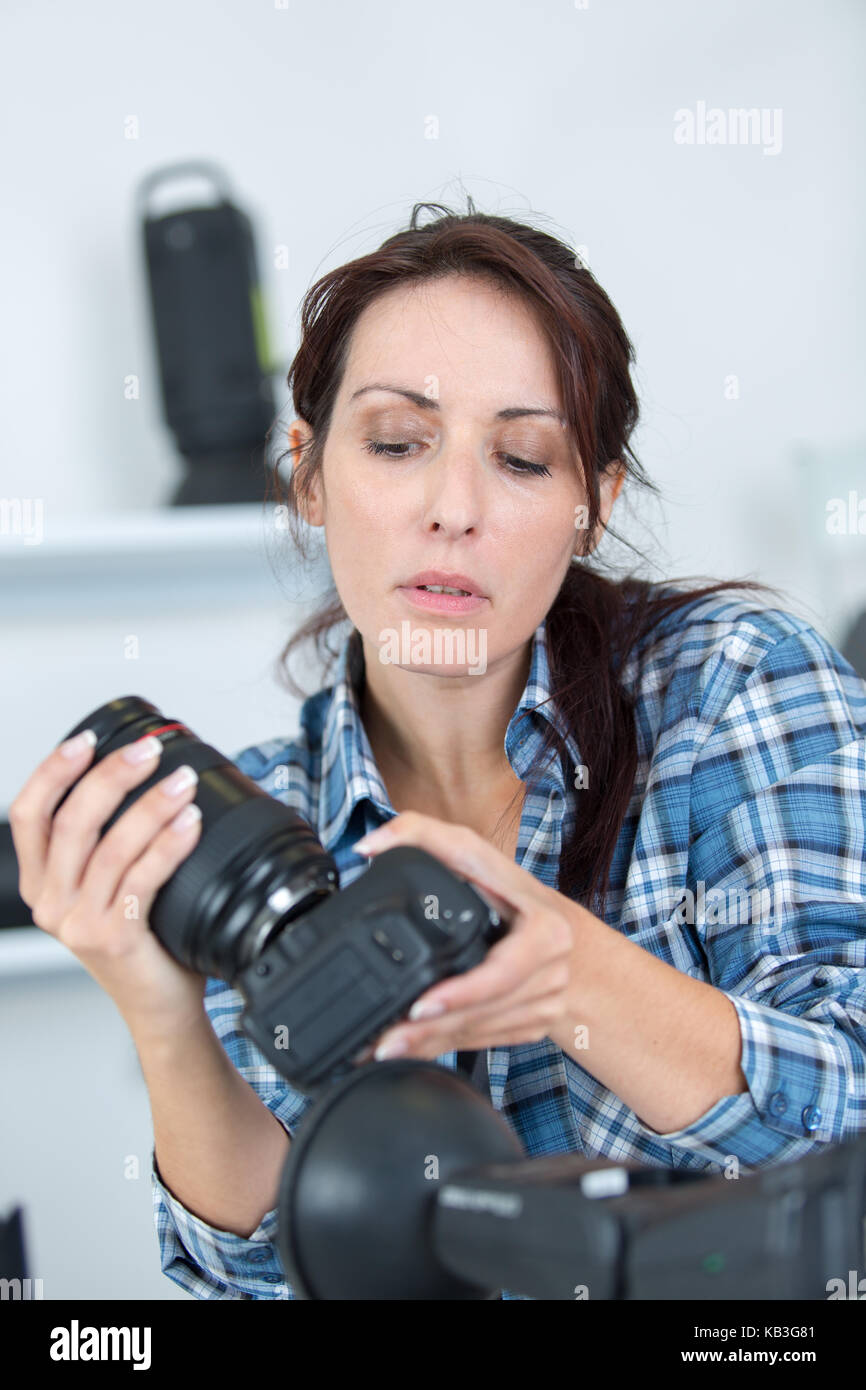 professional photographer showing how to use camera gear Stock Photo