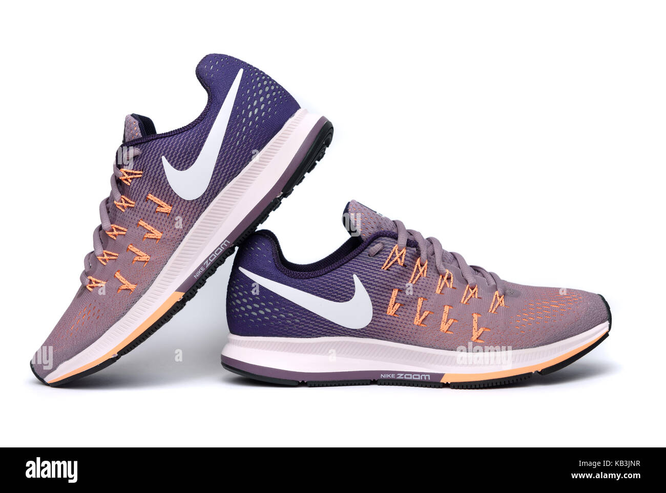 Purple nike zoom 33 shoes and orange Nike Pegasus 33 running shoes isolated on white