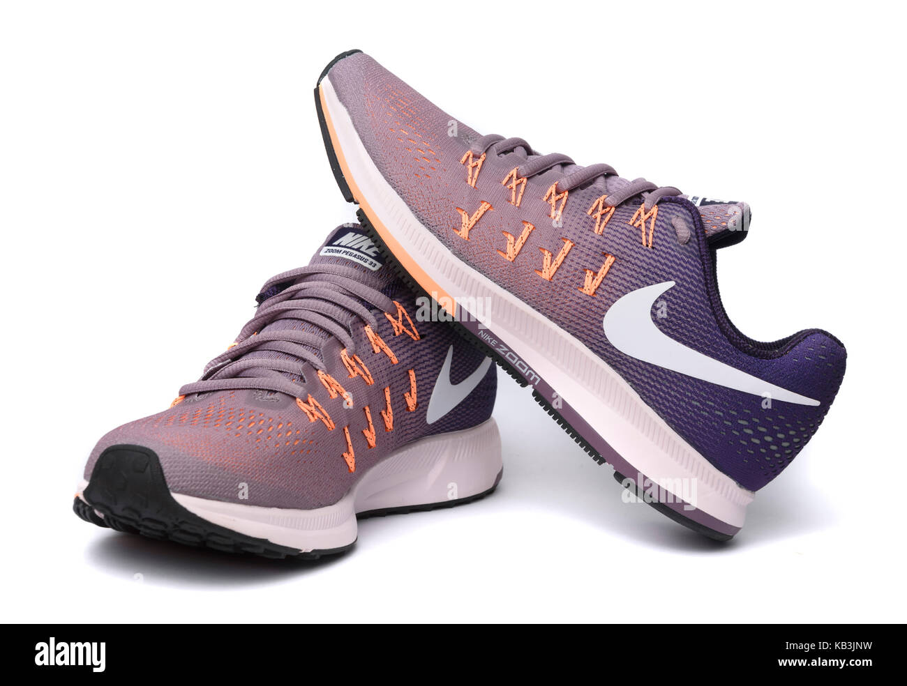 Purple and orange Nike Pegasus 33 running shoes cutout isolated on white  background Stock Photo - Alamy