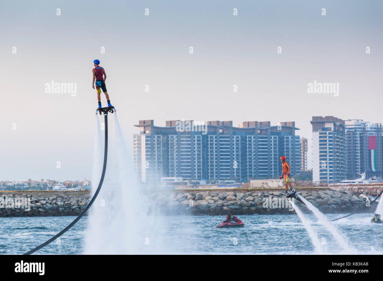 UAE, Dubai, Dubai Marina, Jumeirah Beach, water jet pack stunt flyers, dusk Stock Photo