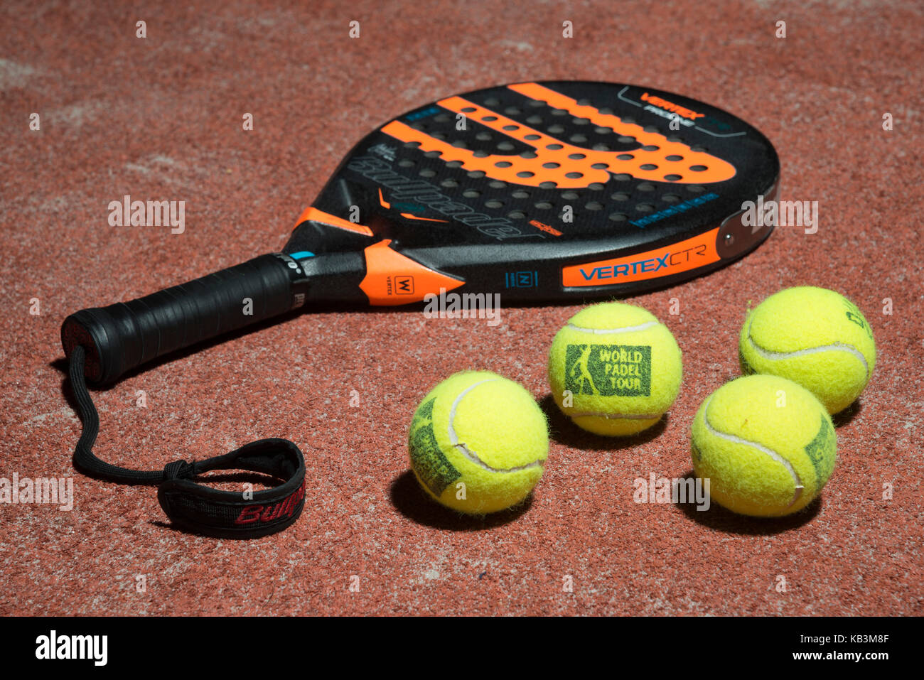 Padel tennis racket and balls on a padel field Stock Photo