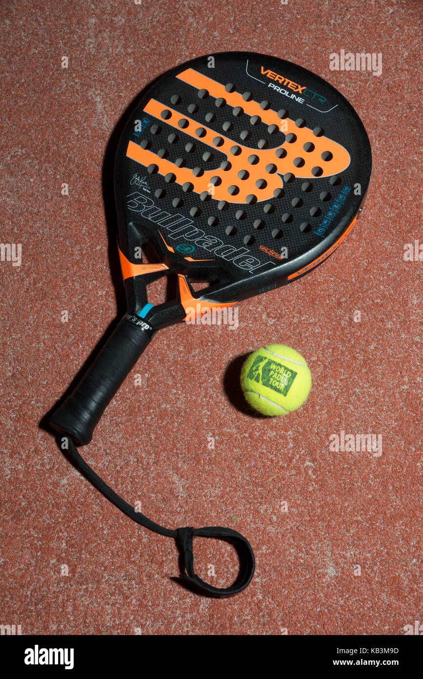 Padel tennis racket and balls on a padel field Stock Photo