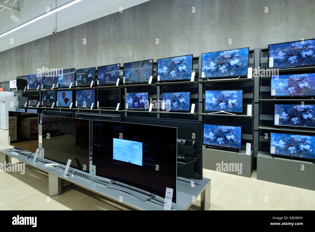 Flat screen televisions at an electronics store Stock Photo