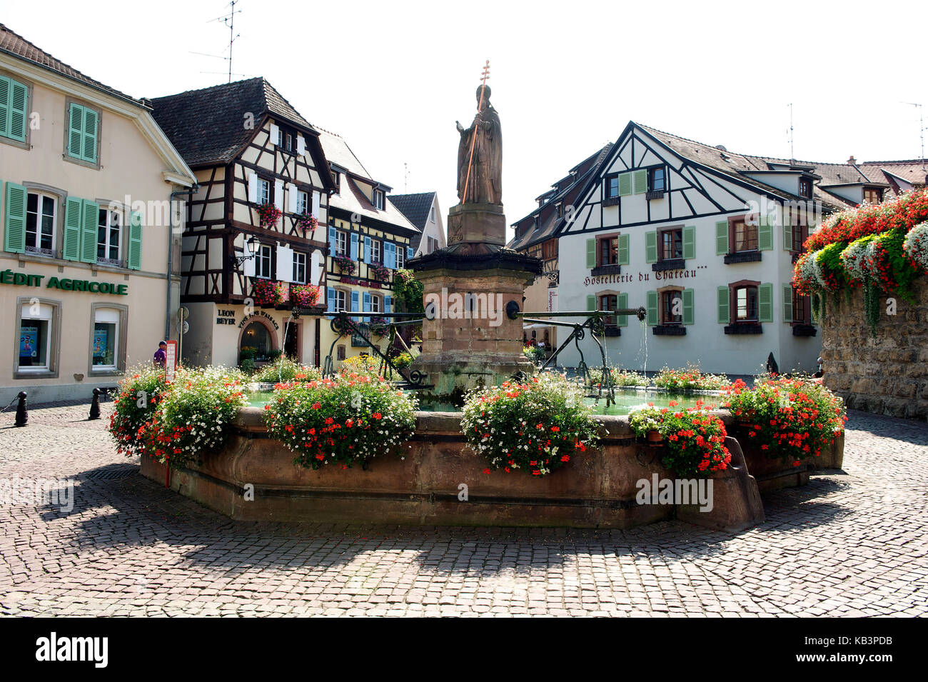 France, Haut Rhin, Alsace Wine Route, Eguisheim, labelled Les Plus Beaux Villages de France (The Most Beautiful Villages of France), Castle square, the fountain surmounted of a statue of the Pope Leon XI Stock Photo