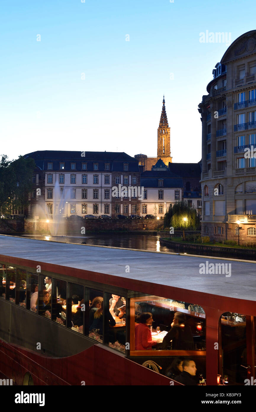 France, Bas Rhin, Strasbourg, old town listed as World Heritage by UNESCO, cafes boats on the Quai des Bateliers on the banks of the Ill river and Notre Dame Cathedral in the background Stock Photo