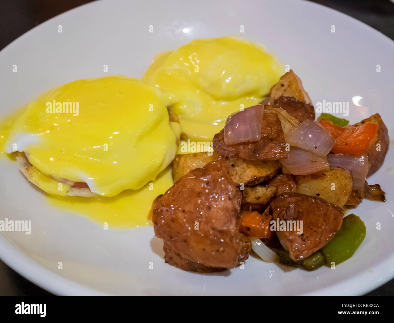 Delicious egg benedict serve with fry potato, ate at Los Angeles, California, United States
