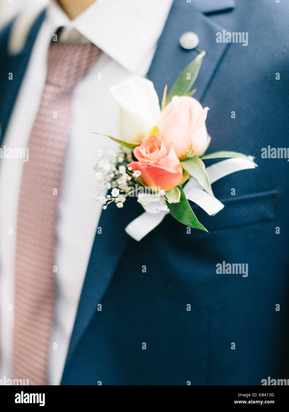 boutonniere flower on suit jacket of wedding groom. groom's boutonniere Stock Photo