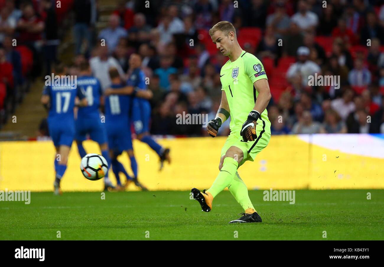 Joe Hart of England kicks the ball out after being beaten by Stanislav