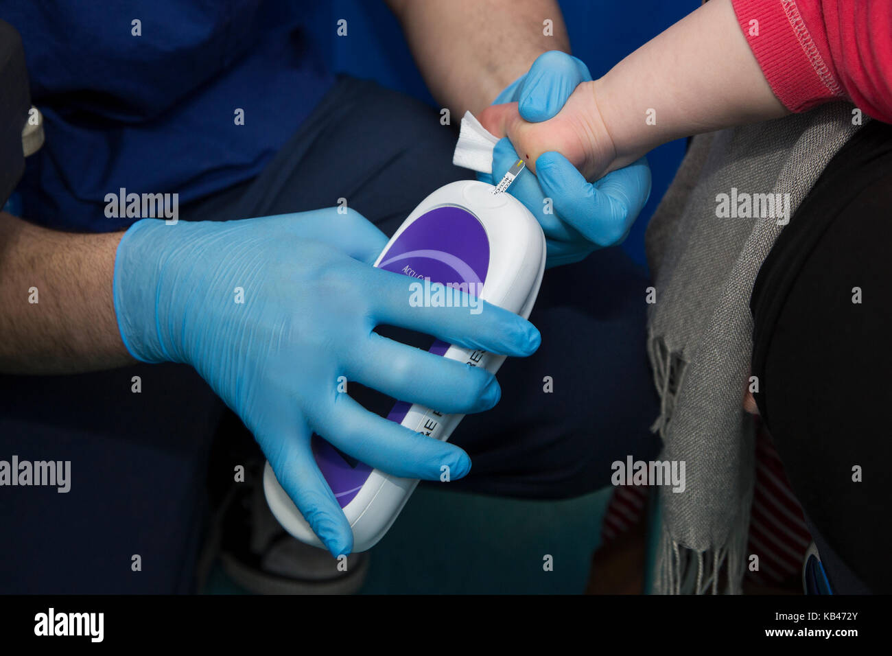 Accu-Check measuring a childs blood glucose levels Stock Photo