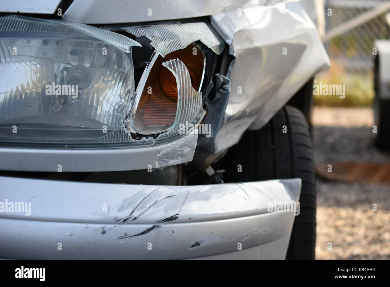 Front view of damaged silver car after accident. Stock Photo