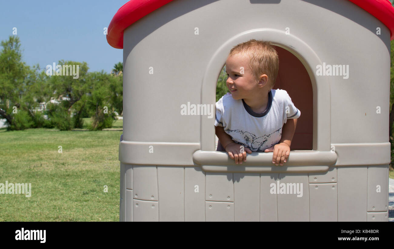 Cute little boy in toy house Stock Photo - Alamy